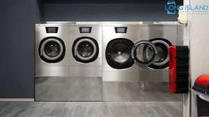 A high-end industrial laundry room with large steel machines, showing the scale of investment required