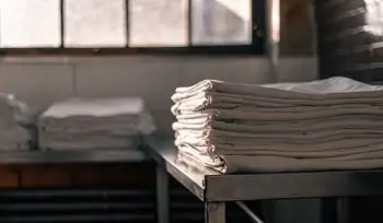 Clean healthcare linens folded on a table.