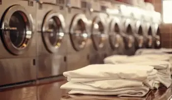 Clean, folded medical linens in Syosset laundry facility.