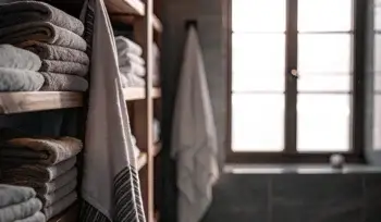 Clean, folded towels stacked on wooden shelves.