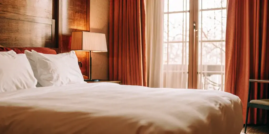 Clean, fluffy comforter on a made bed.