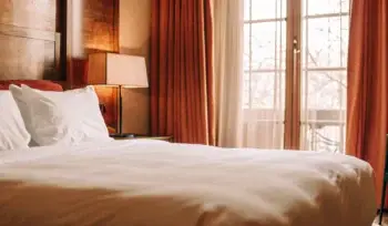 Clean, fluffy comforter on a made bed.