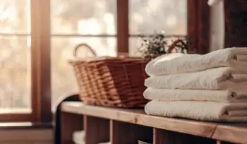Clean towels folded in a wicker basket. Glen Head towel service.