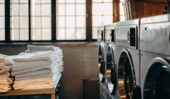Clean, folded towels in a Plainview medical laundry facility.