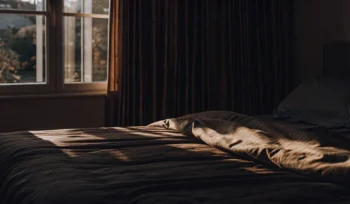 Clean comforter on a made bed.