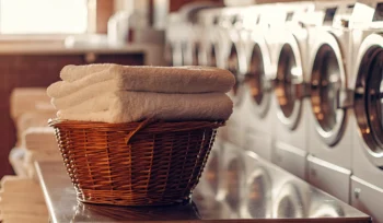 A basket of folded towels from the best commercial laundry service in East Hills.