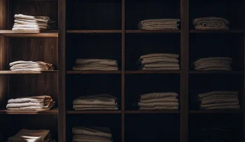 Clean healthcare linen from a service provider in Upper Brookville, neatly folded on shelves.
