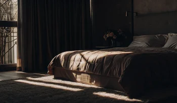 A clean comforter on a bed after professional comforter cleaning in East Hills.