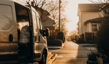 A laundry delivery van making a stop in a residential Garden City neighborhood.