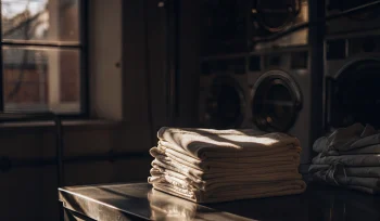 Sanitized medical laundry folded and ready for delivery at a professional laundry service in Bethpage.