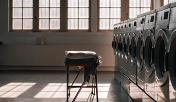 Neatly folded laundry and modern machines at the best laundromat in Locust Valley.