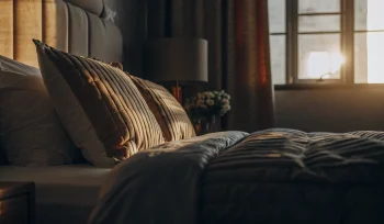 A clean, fluffy comforter on a bed after professional cleaning in Cove Neck.