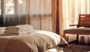 A freshly cleaned comforter on a bed from a professional cleaning service in Brookville.