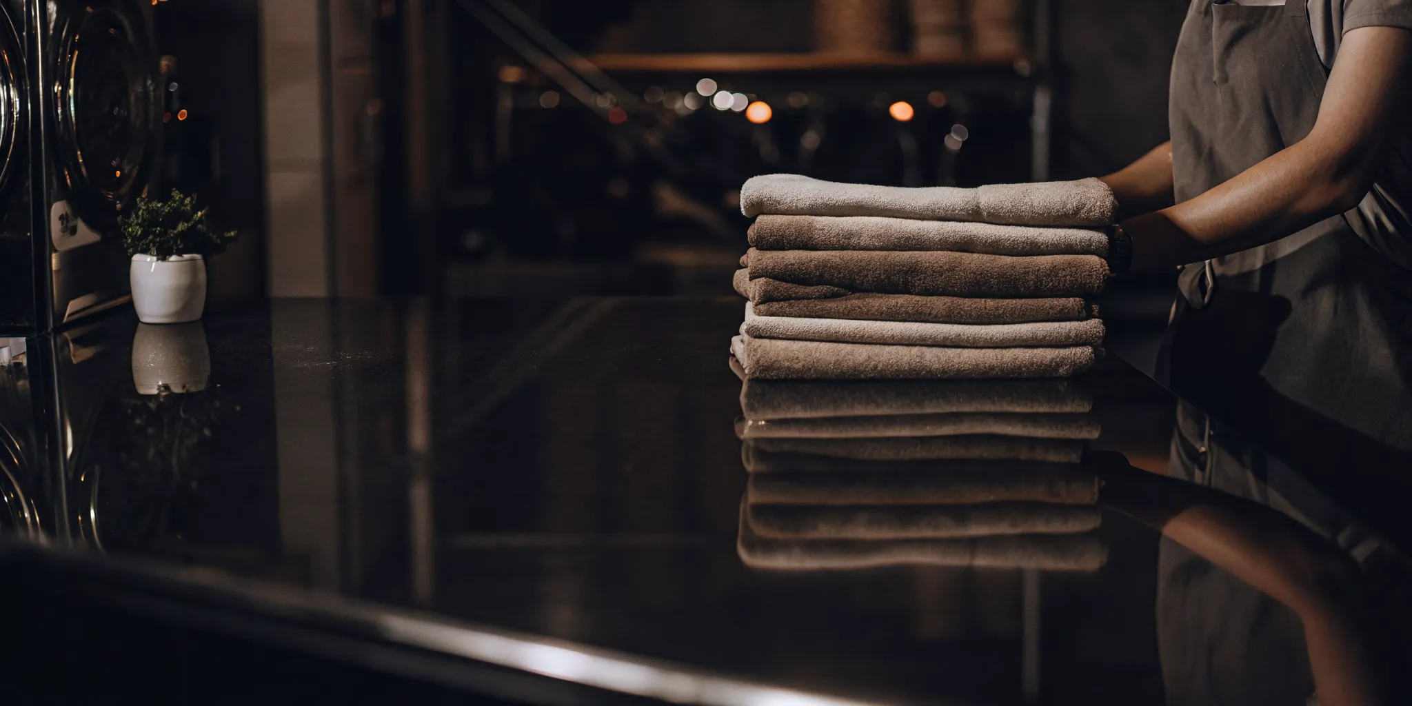 Stack of clean, folded towels from a professional towel laundry service in Commack.