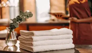 A stack of clean towels from a professional towel laundry service in Glen Cove.