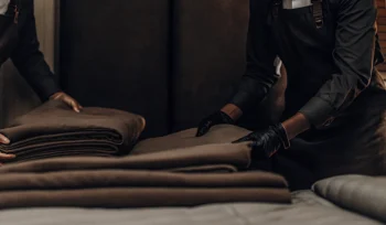 A crisp, clean comforter being folded by a professional cleaning service in Hicksville.