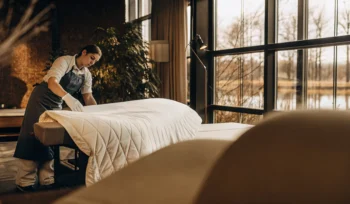 Professional preparing a comforter for deep cleaning at a Lake Success laundry service.