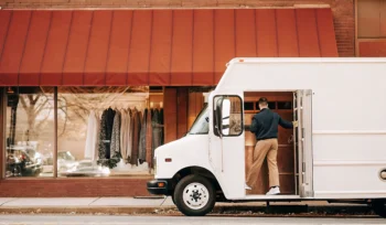 Driver collecting garments for a dry cleaning pickup service in Amityville.