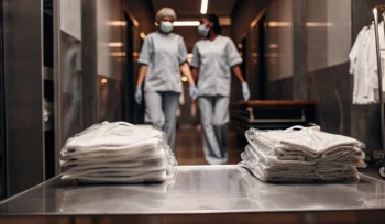 Clean medical laundry and scrubs prepared by a professional service for a Sea Cliff healthcare facility.