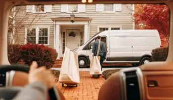 A driver collects bags for a laundry pickup service in Commack.