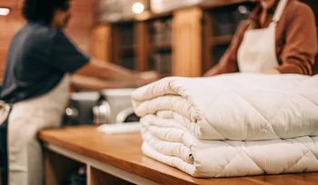 A stack of freshly cleaned comforters at a professional cleaning service in Plainview.