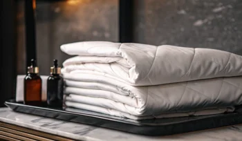 A professionally cleaned white comforter, folded and ready for delivery in West Hills.