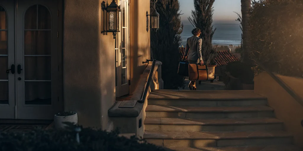 A man makes a laundry delivery to a home in Sea Cliff with an ocean view.