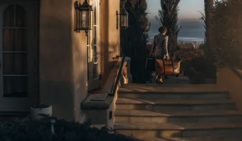 A man makes a laundry delivery to a home in Sea Cliff with an ocean view.