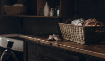 Basket of clean baby clothes from a Long Island laundry service.