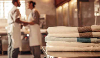Clean, folded towels from a commercial laundry service for businesses on Long Island.