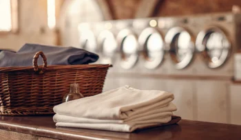 Freshly folded laundry in a basket at a Sayville wash and fold service.