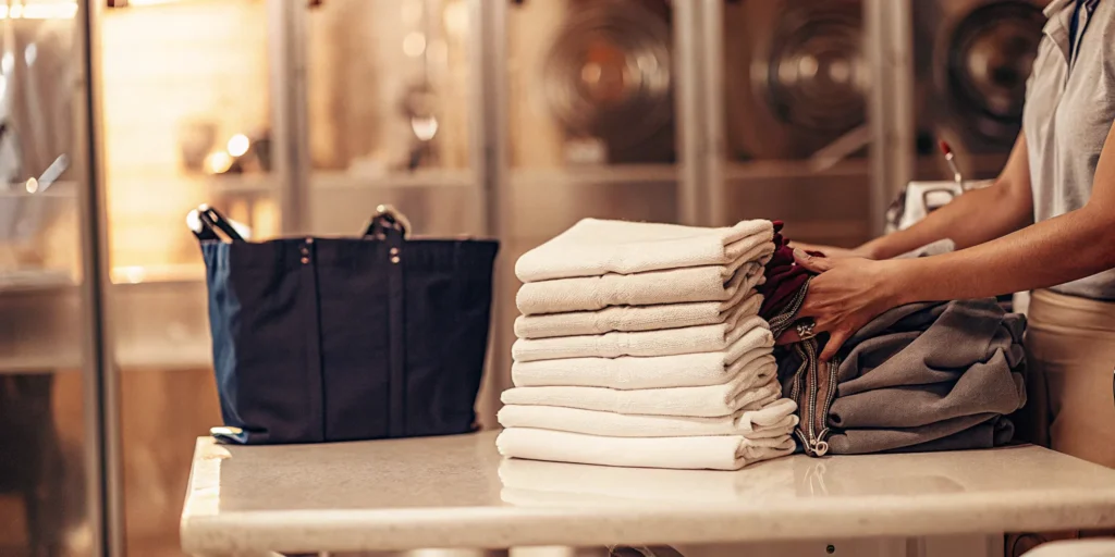 A stack of professionally folded laundry from a wash and fold service in Smithtown.