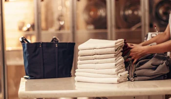 A stack of professionally folded laundry from a wash and fold service in Smithtown.