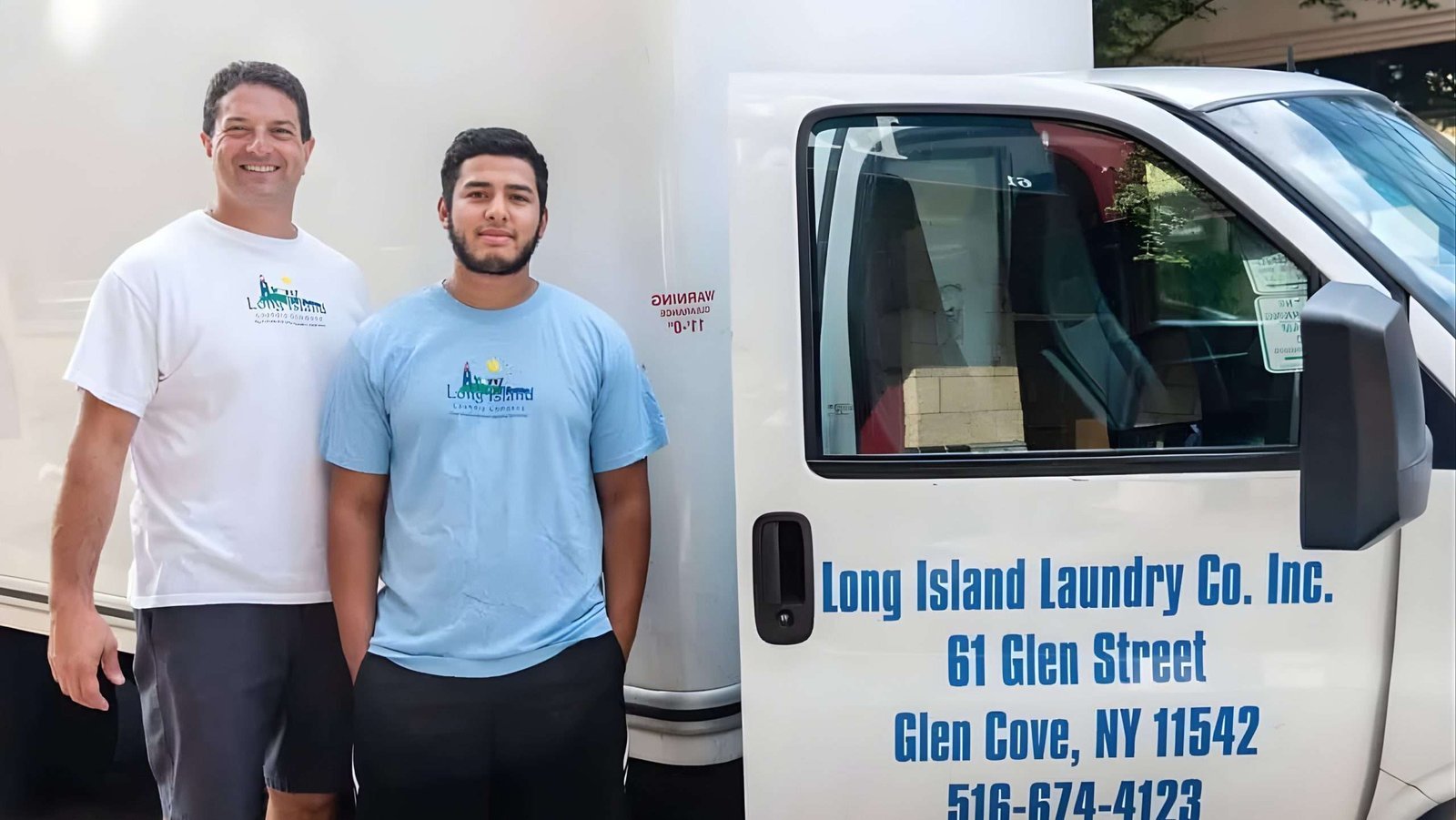 Anthony and a team member beside the Long Island Laundry Company delivery truck in Glen Cove