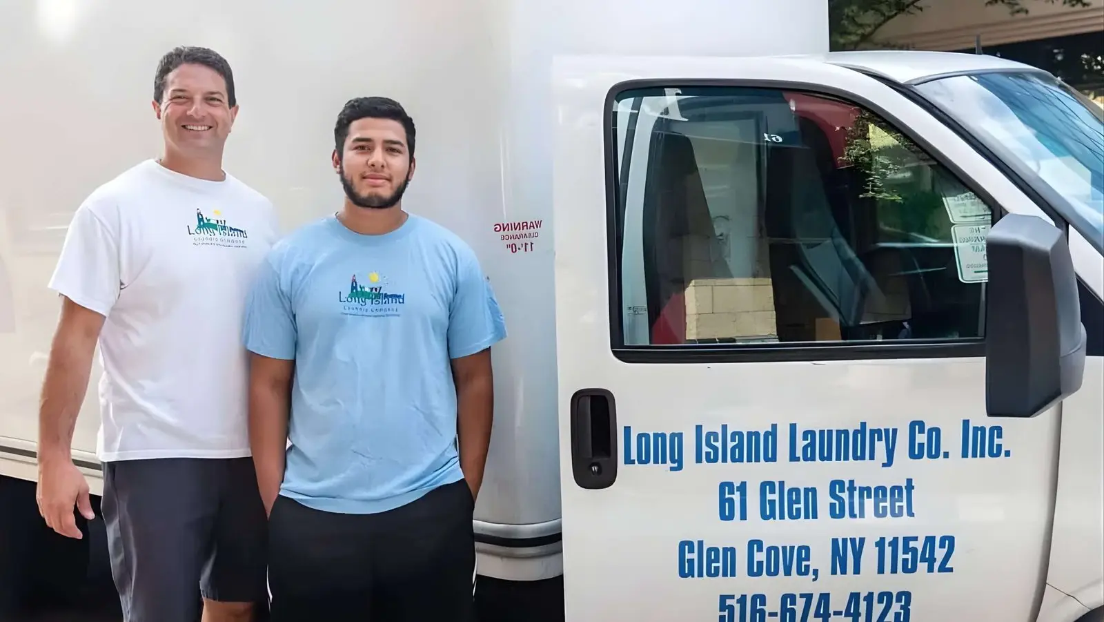 Anthony and a team member beside the Long Island Laundry Company delivery truck in Glen Cove