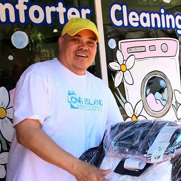 Long Island Laundry Company driver with a finished laundry order outside 61 Glen Street, Glen Cove