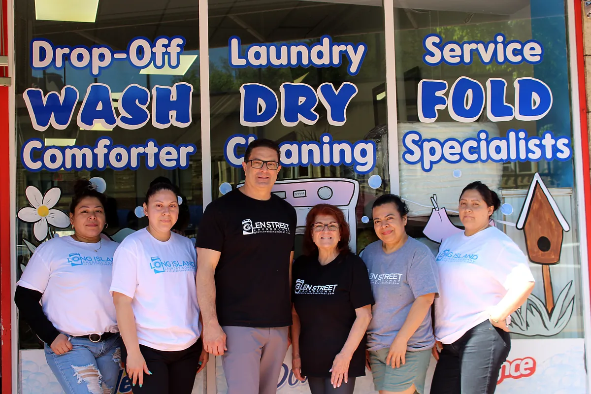 Long Island Laundry Company team with owner Anthony and Marietta in front of the Glen Cove store