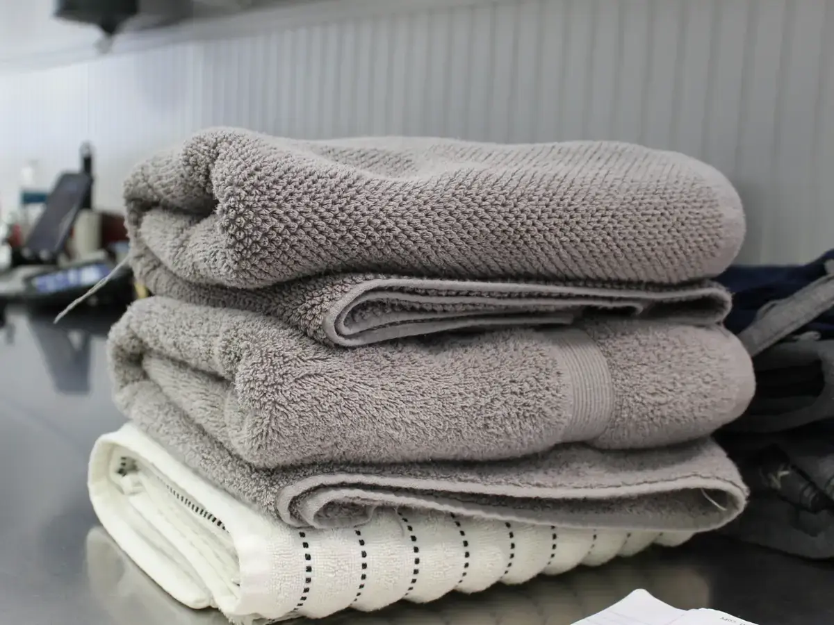 Folded grey and white spa towels ready for delivery